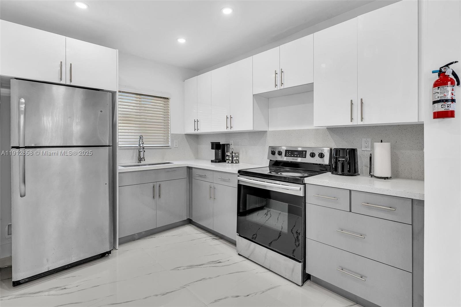 797 Northwest 35th Street Miami, FL 33127 - Photo 14 of 45 a kitchen with cabinets stainless steel appliances and counter space