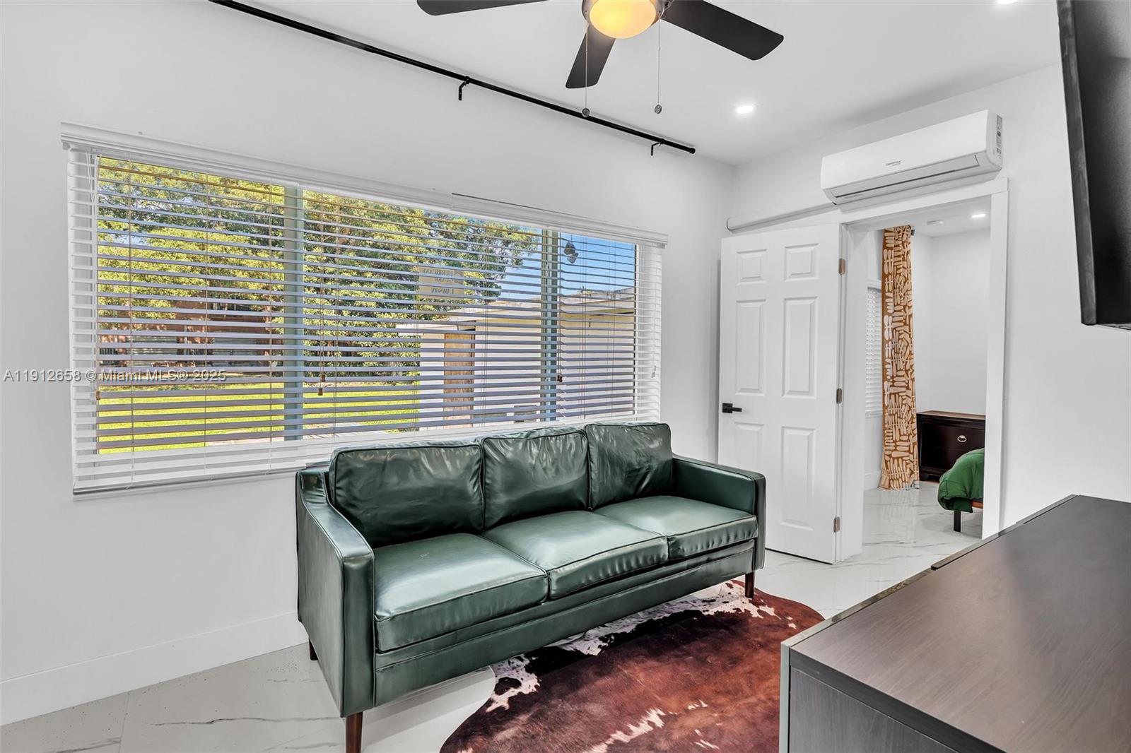 797 Northwest 35th Street Miami, FL 33127 - Photo 19 of 45 a living room with furniture and a window