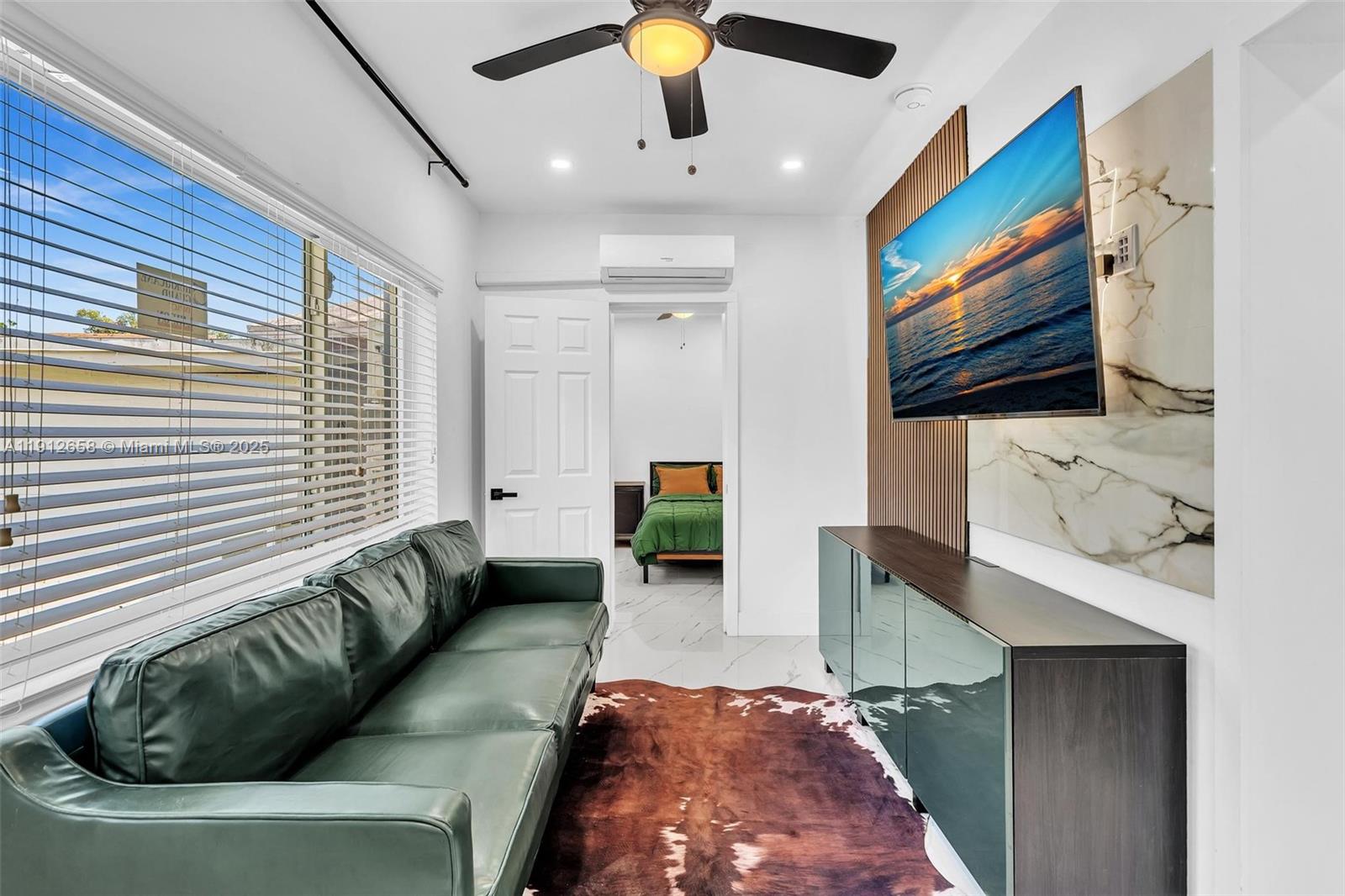 797 Northwest 35th Street Miami, FL 33127 - Photo 20 of 45 a living room with furniture and a flat screen tv