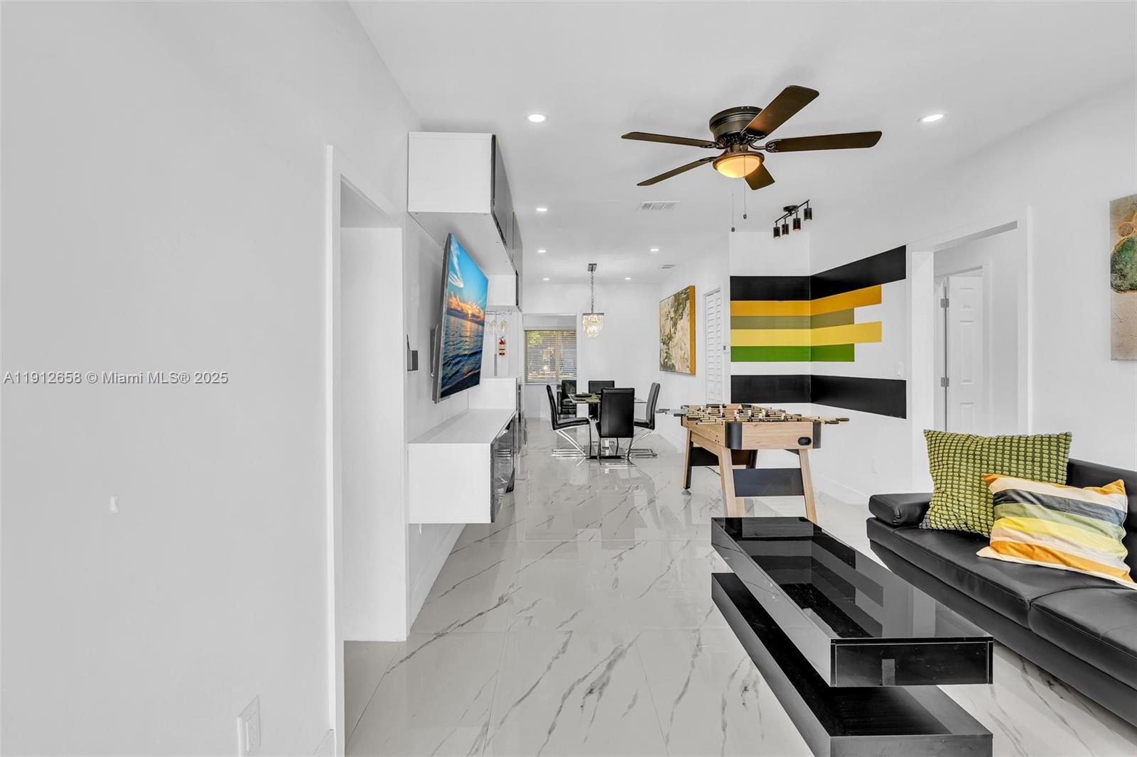 797 Northwest 35th Street Miami, FL 33127 - Photo 2 of 45 a room with furniture and a flat screen tv