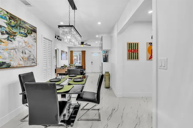 a view of a dining room with furniture a kitchen and a window