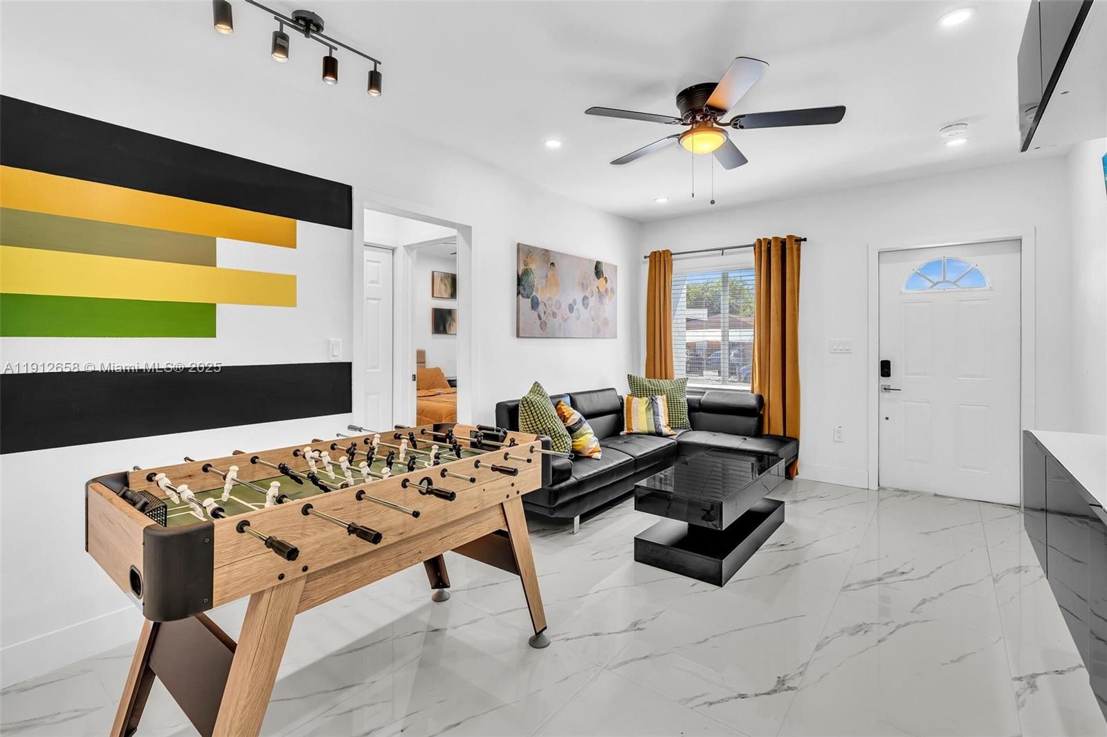 797 Northwest 35th Street Miami, FL 33127 - Photo 26 of 45 a living room with furniture and a large window