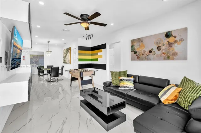 a living room with furniture and a flat screen tv