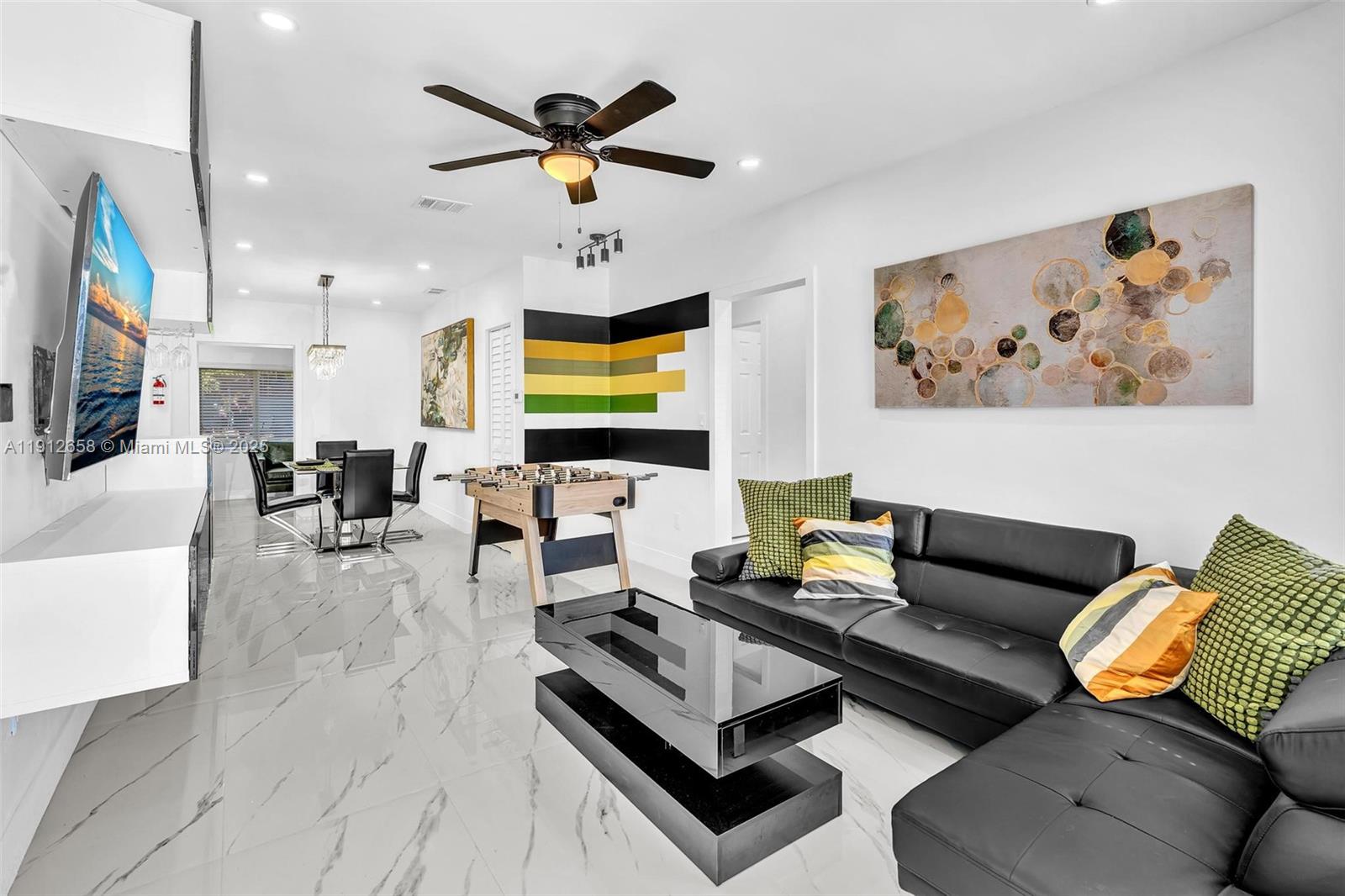 797 Northwest 35th Street Miami, FL 33127 - Photo 3 of 45 a living room with furniture and a flat screen tv