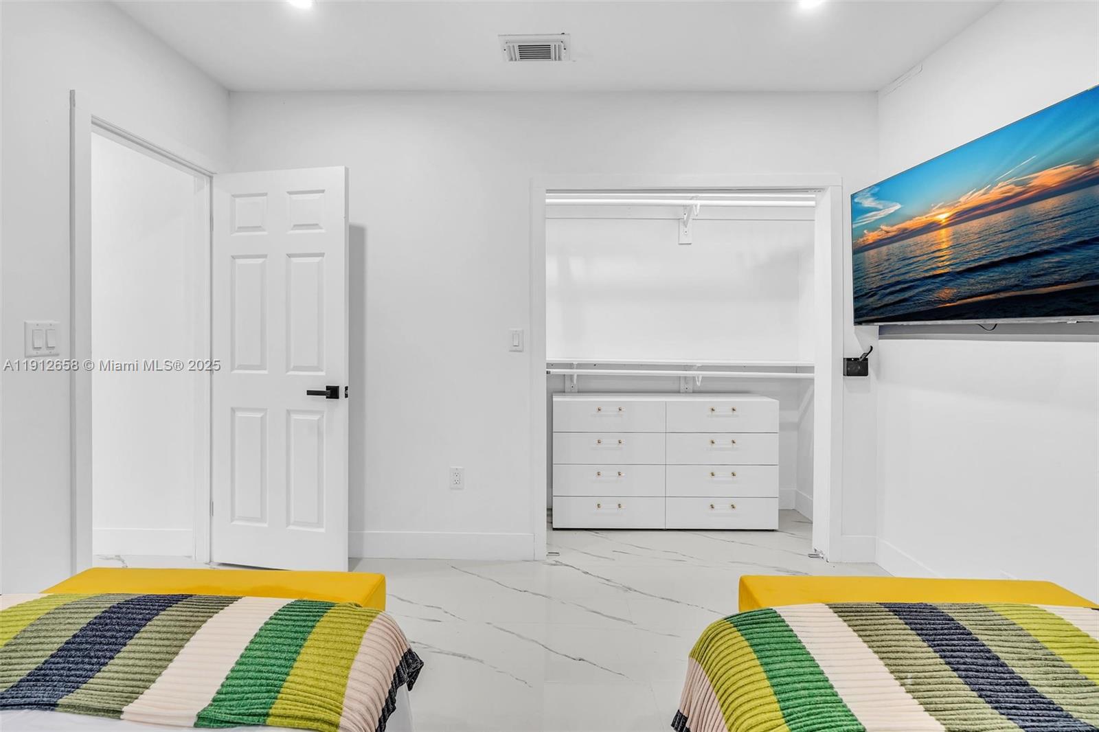 797 Northwest 35th Street Miami, FL 33127 - Photo 32 of 45 a bedroom with a bed and a cabinets