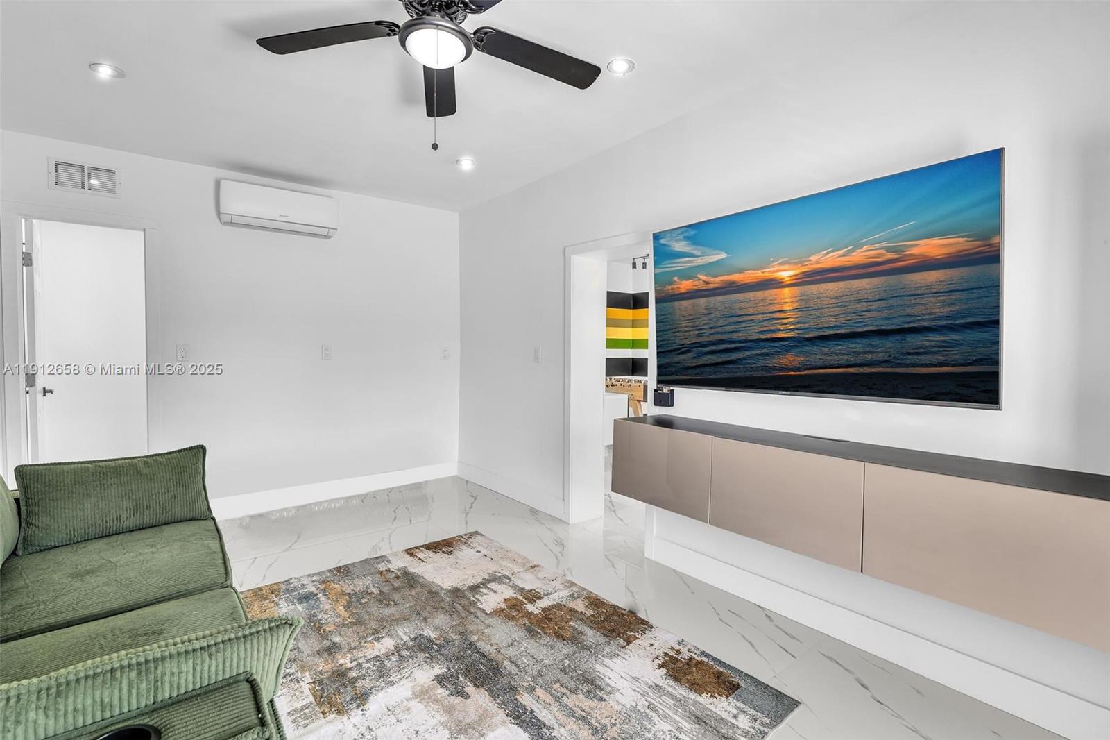 797 Northwest 35th Street Miami, FL 33127 - Photo 37 of 45 a living room with furniture and a flat screen tv