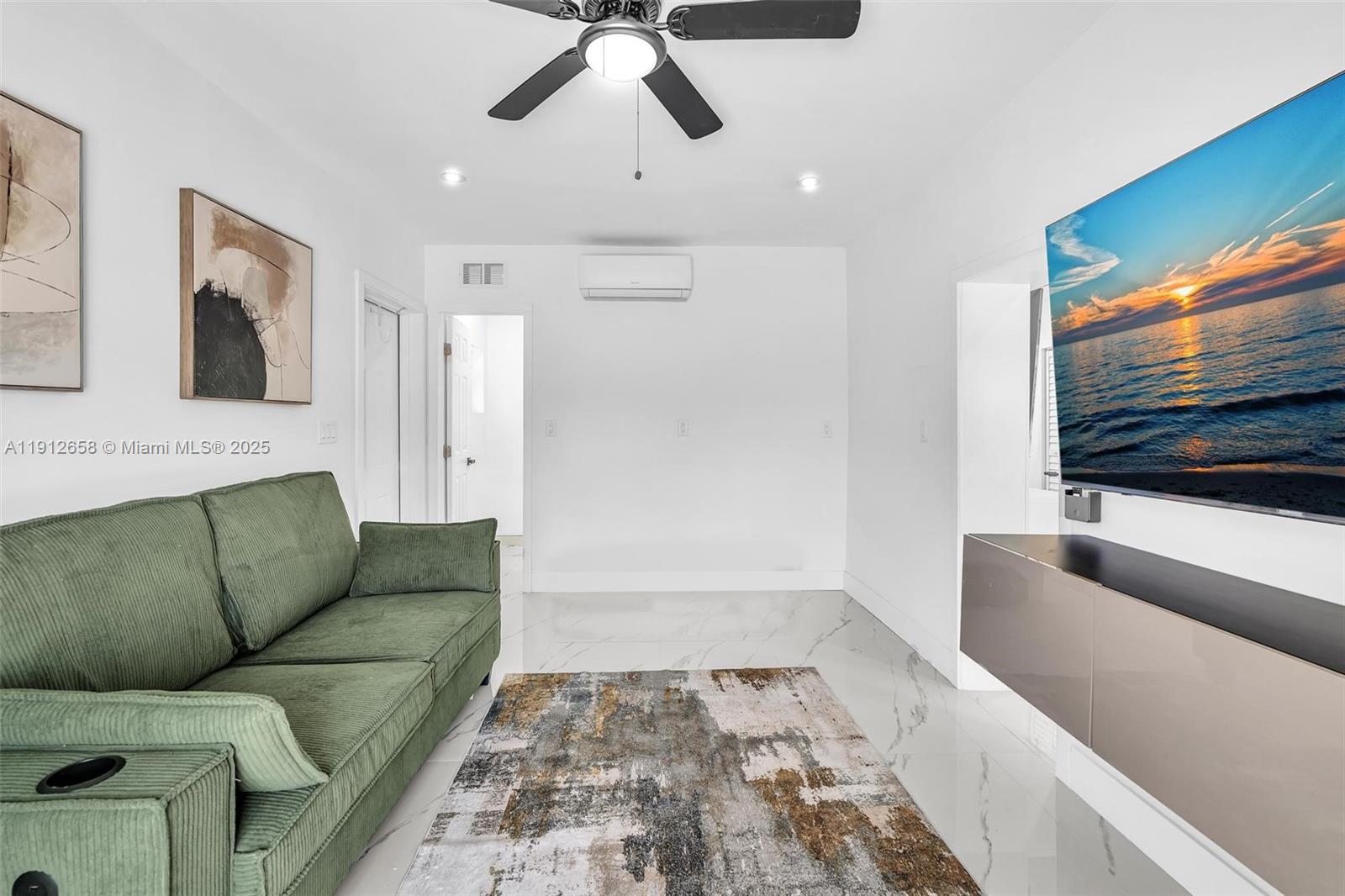 797 Northwest 35th Street Miami, FL 33127 - Photo 38 of 45 a living room with furniture and a flat screen tv