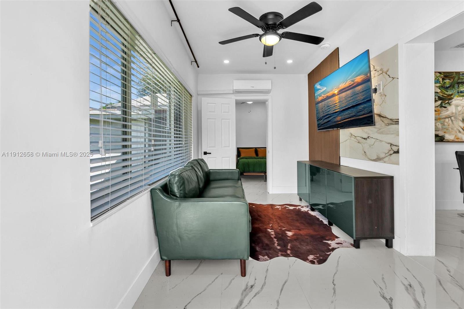 797 Northwest 35th Street Miami, FL 33127 - Photo 39 of 45 a living room with furniture and a flat screen tv