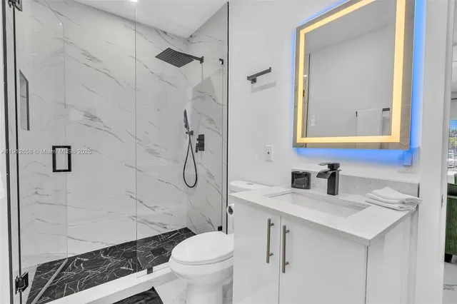 a bathroom with a sink toilet and shower