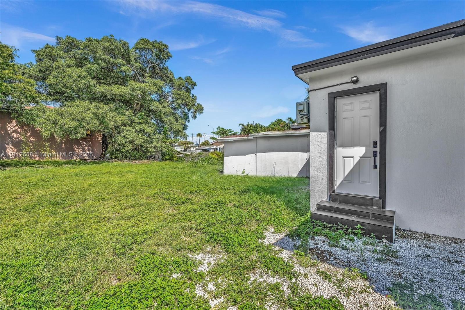797 Northwest 35th Street Miami, FL 33127 - Photo 43 of 45 a front view of a house with garden