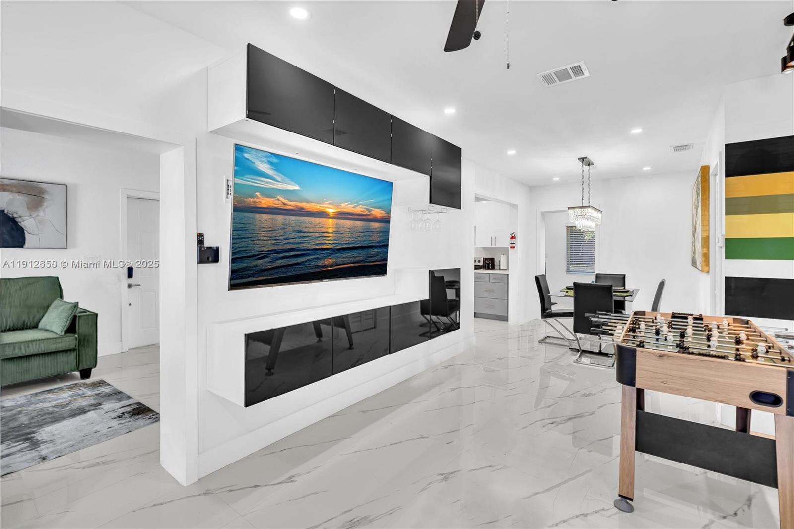 797 Northwest 35th Street Miami, FL 33127 - Photo 5 of 45 a living room with furniture and a flat screen tv