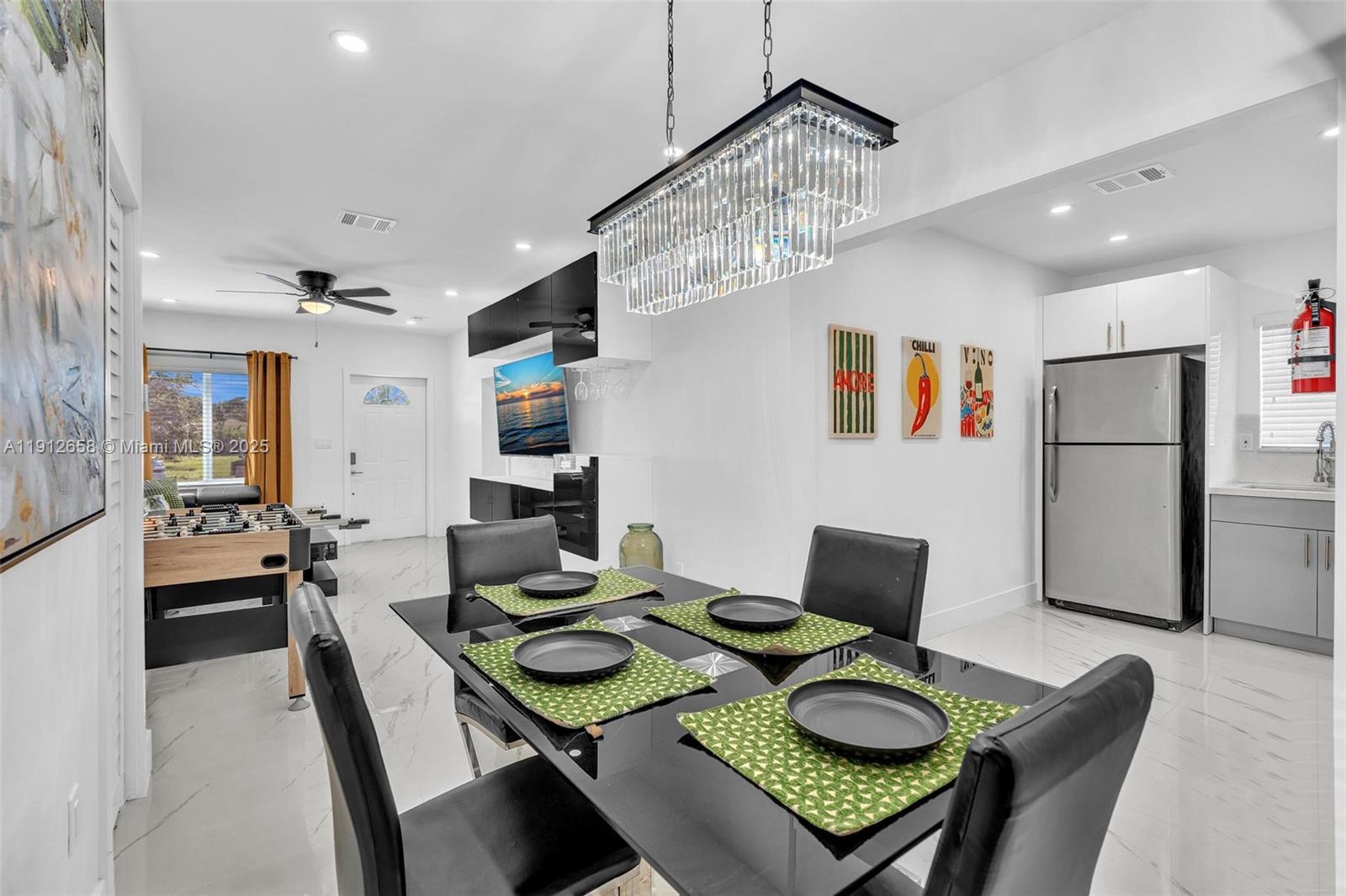 797 Northwest 35th Street Miami, FL 33127 - Photo 10 of 45 a view of a dining room with furniture and wooden floor