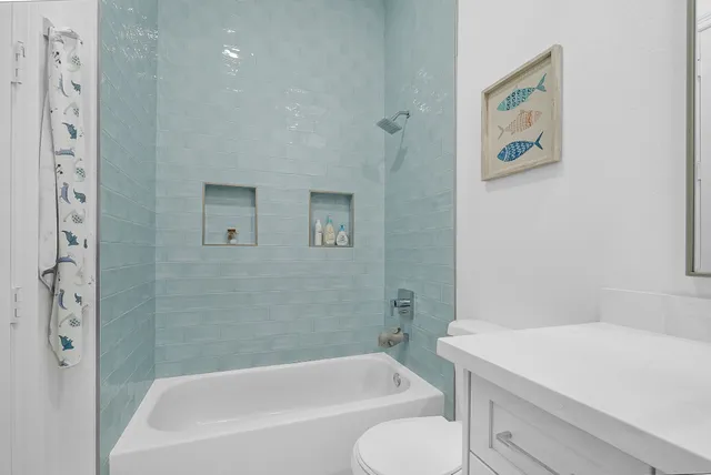 a bath room with a toilet and a bath tub