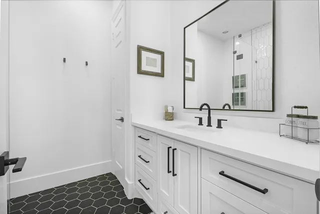 a bathroom with a double vanity sink and mirror