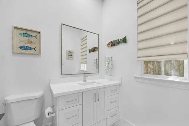 a bathroom with a sink a mirror and a toilet