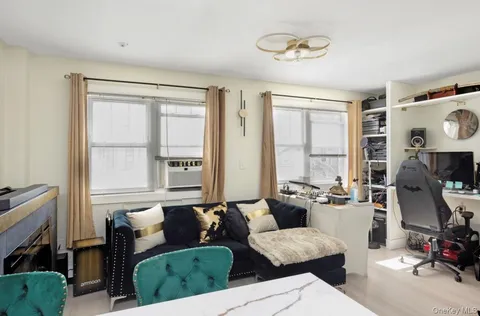 a bed sitting in a bedroom next to a bathroom with a wooden floor