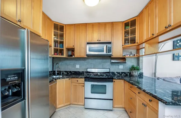 a living room with furniture and a view of kitchen
