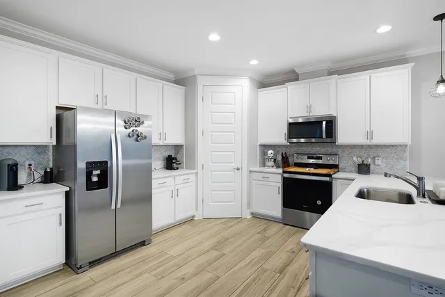 a kitchen with a refrigerator stove and microwave