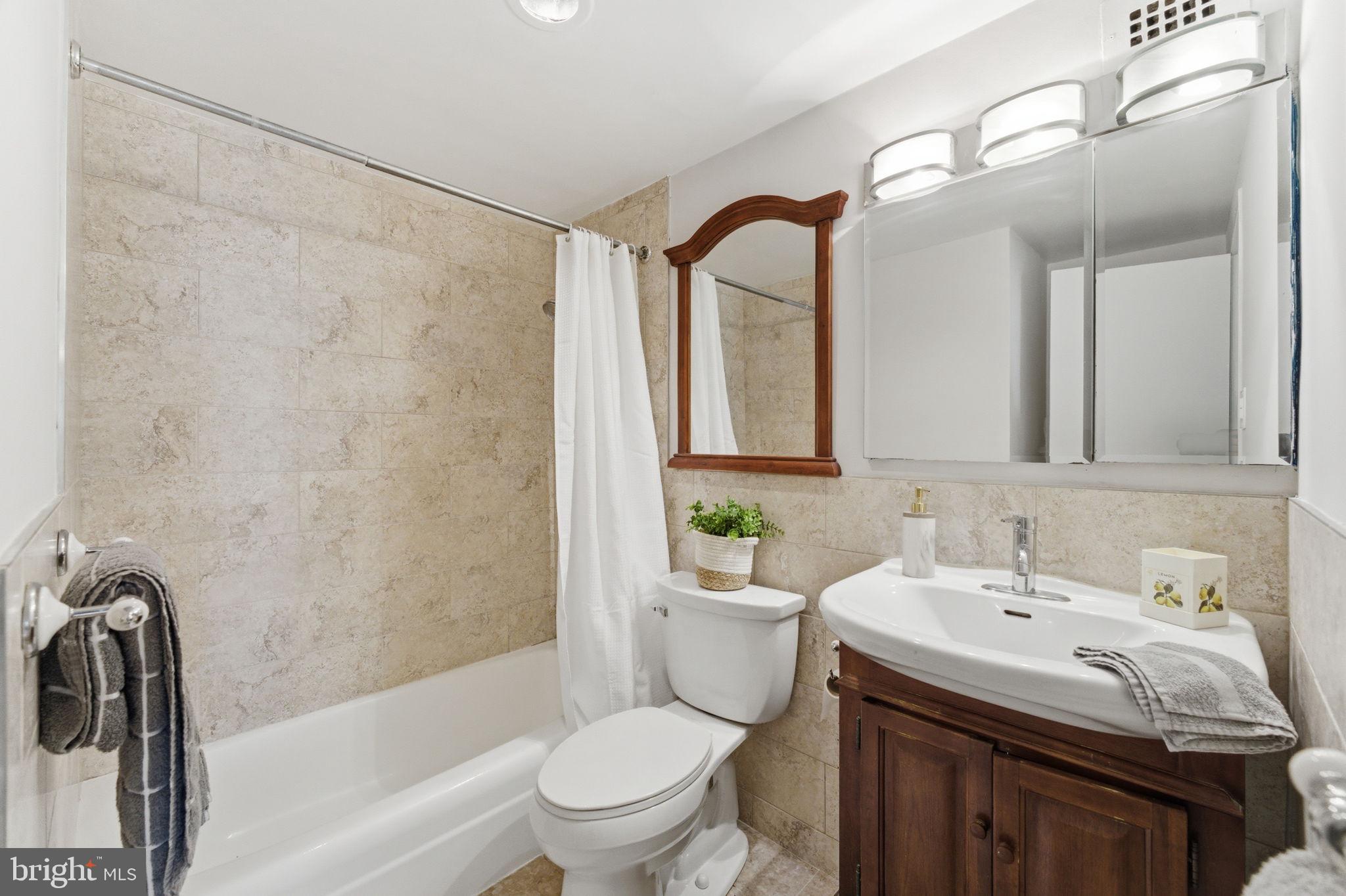 1435 4th Street Southwest, Unit B609 Washington, DC 20024 - Photo 23 of 52 a bathroom with a sink toilet and shower