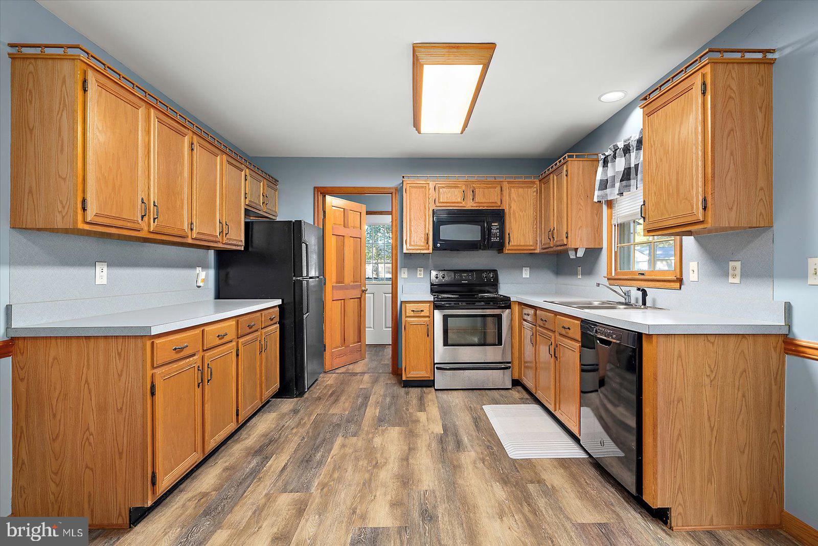 5079 Old Mill Branch Road Salisbury, MD 21801 - Photo 12 of 47 a kitchen with stainless steel appliances a refrigerator sink and cabinets