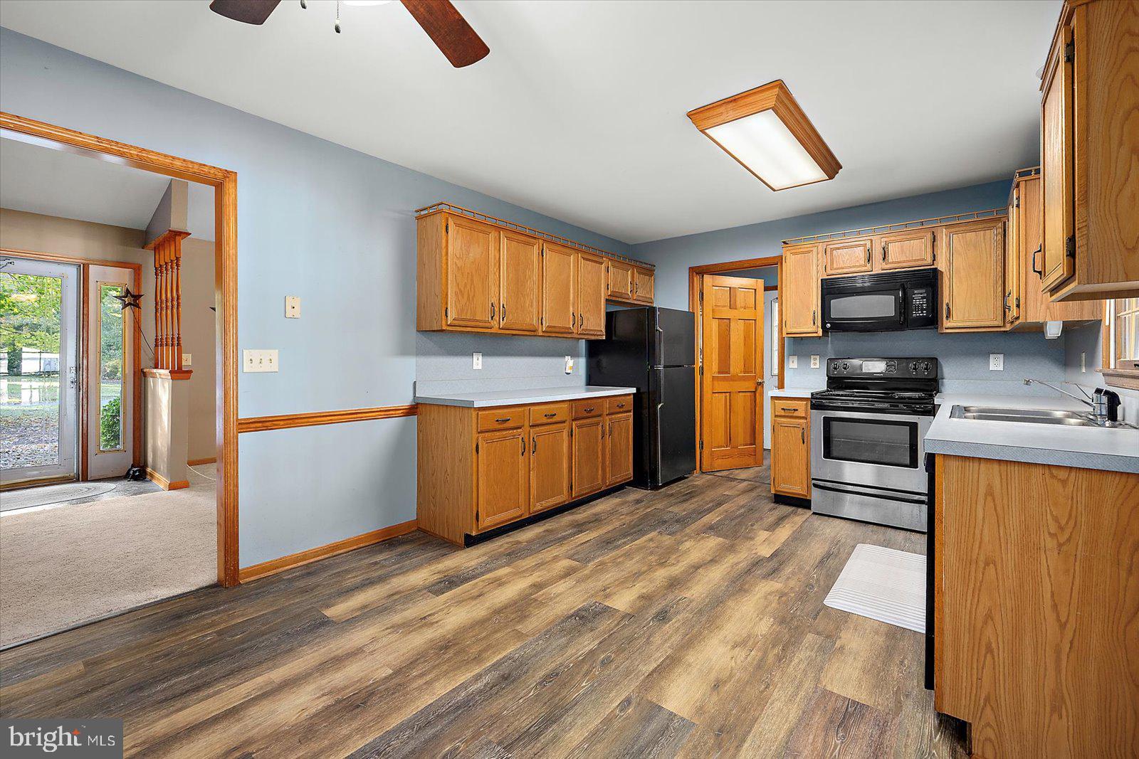 5079 Old Mill Branch Road Salisbury, MD 21801 - Photo 13 of 47 a kitchen with stainless steel appliances granite countertop a stove a sink and a refrigerator
