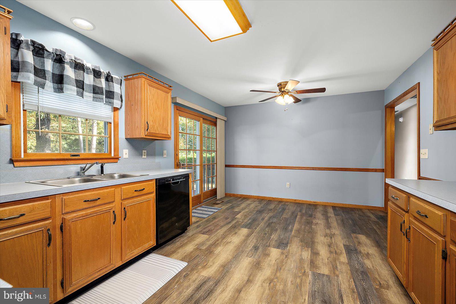 5079 Old Mill Branch Road Salisbury, MD 21801 - Photo 15 of 47 a view of a kitchen with cabinets and wooden floor