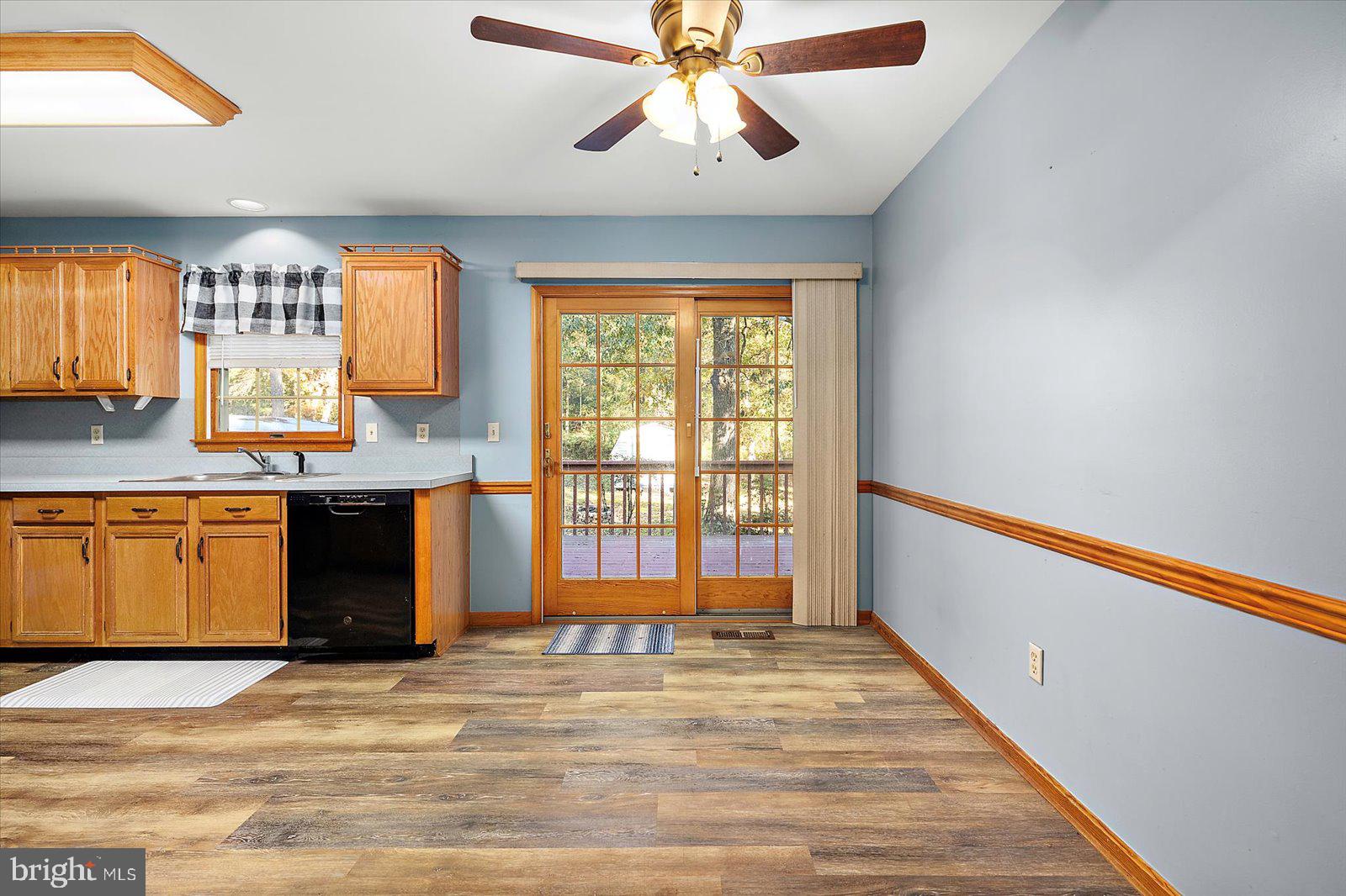 5079 Old Mill Branch Road Salisbury, MD 21801 - Photo 16 of 47 a view of an empty room with window and a kitchen