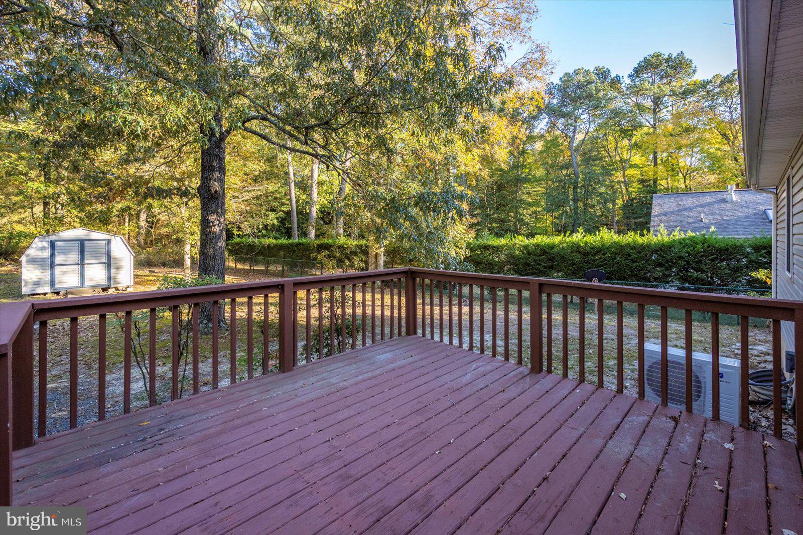 5079 Old Mill Branch Road Salisbury, MD 21801 - Photo 32 of 47 a balcony with wooden floor and trees