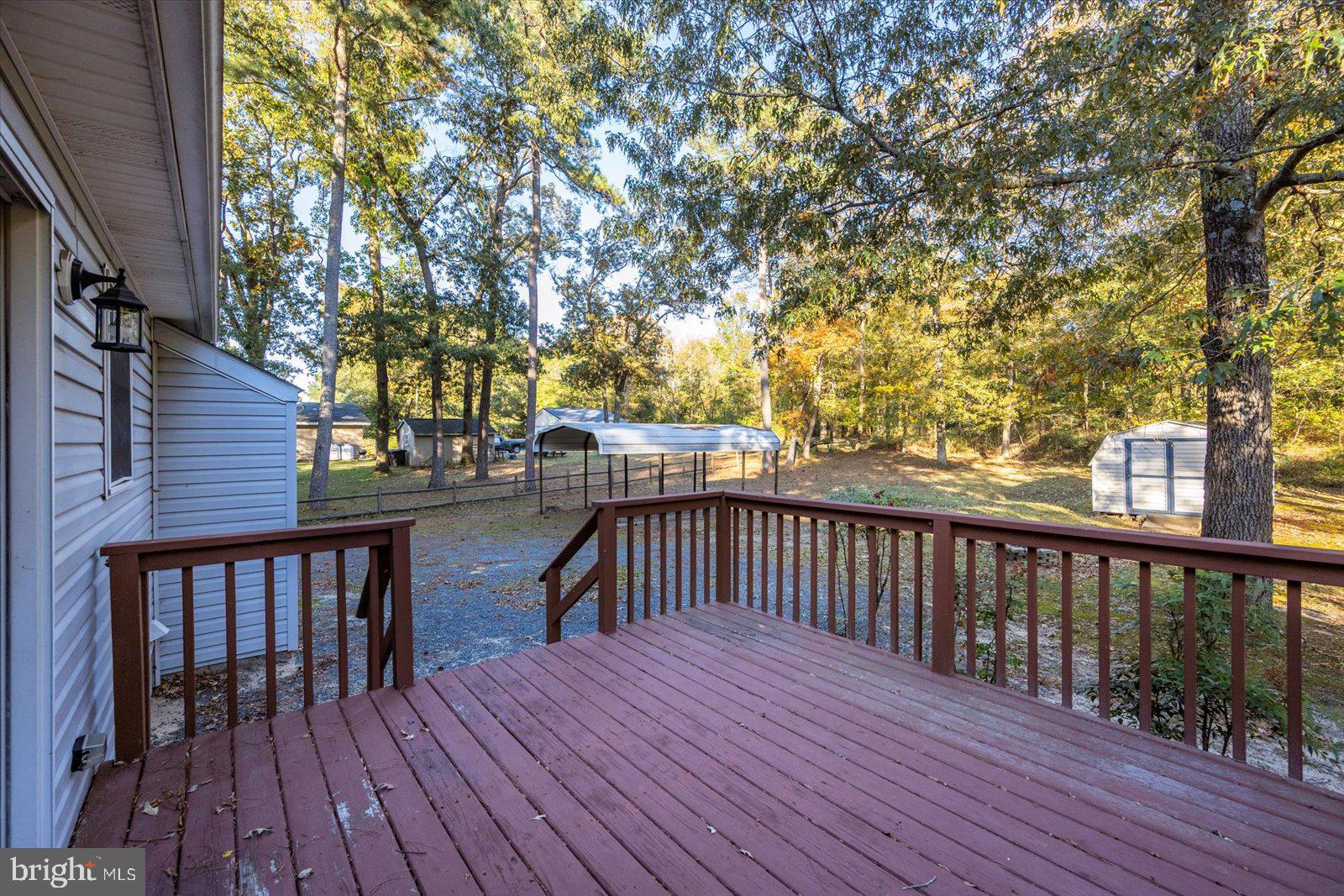 5079 Old Mill Branch Road Salisbury, MD 21801 - Photo 33 of 47 a balcony with wooden floor and fence