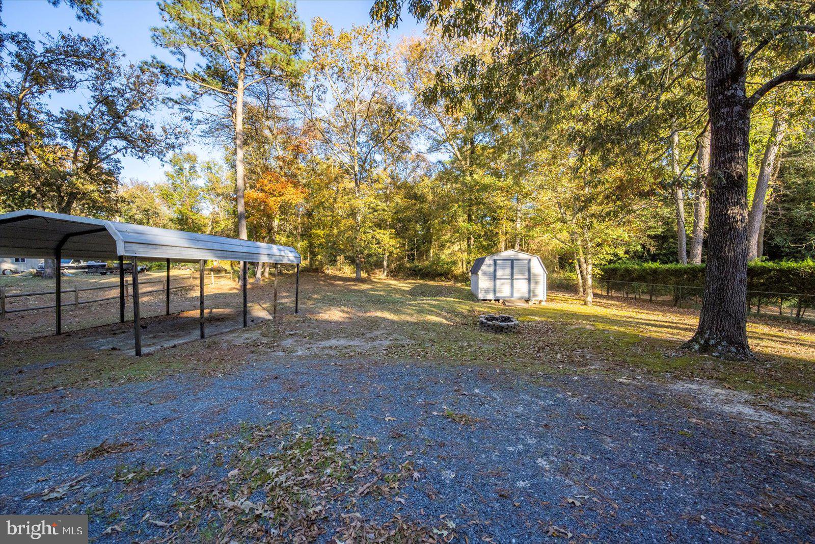 5079 Old Mill Branch Road Salisbury, MD 21801 - Photo 35 of 47 a backyard of a house with table and chairs
