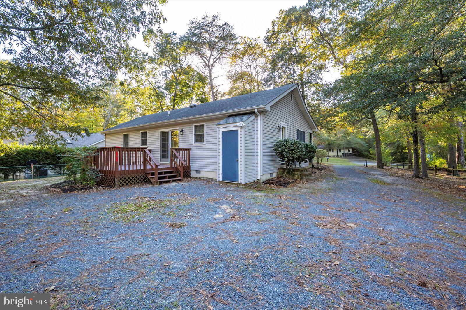 5079 Old Mill Branch Road Salisbury, MD 21801 - Photo 40 of 47 a view of a house with backyard and chairs