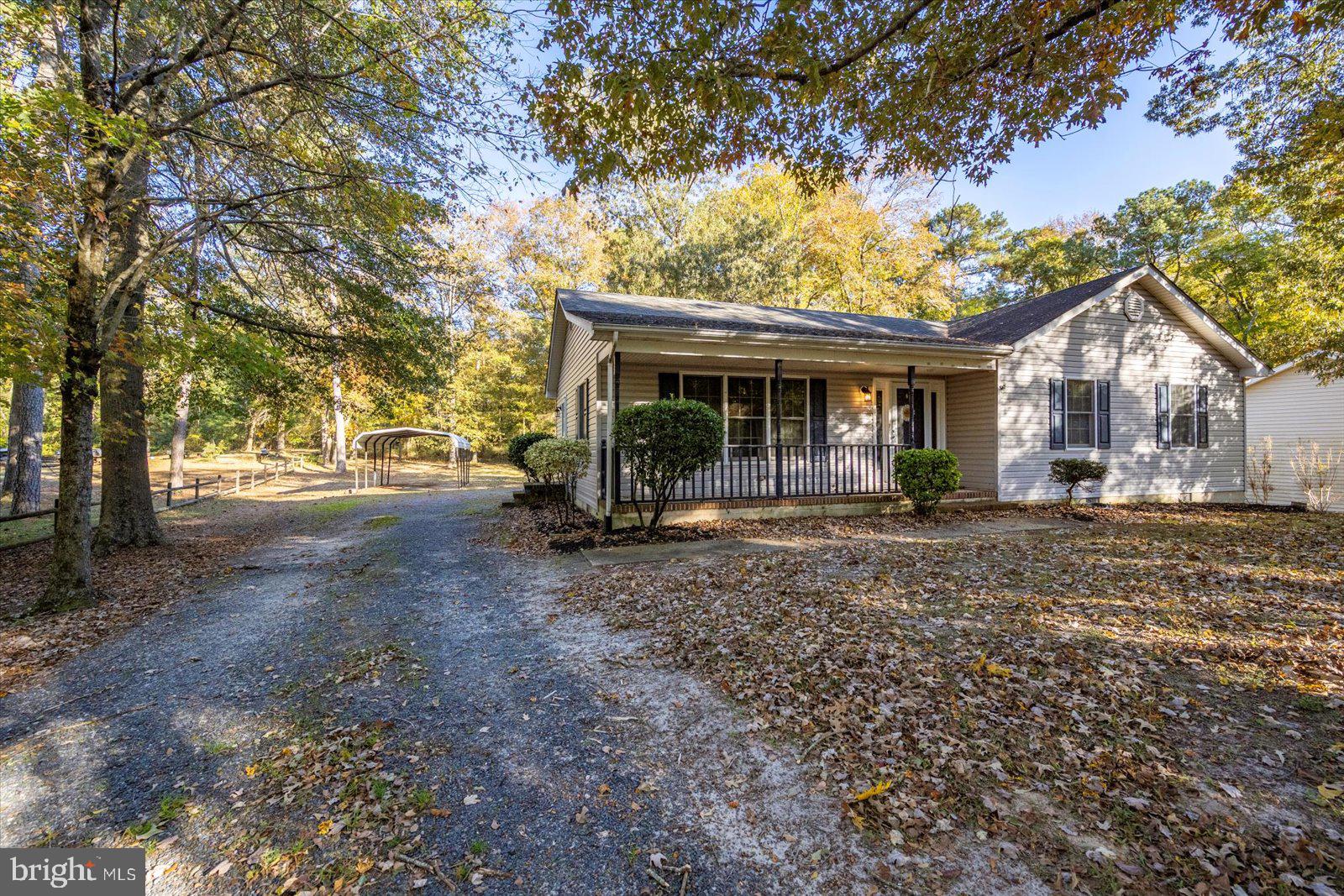 5079 Old Mill Branch Road Salisbury, MD 21801 - Photo 4 of 47 a view of a house with large tree and a big yard