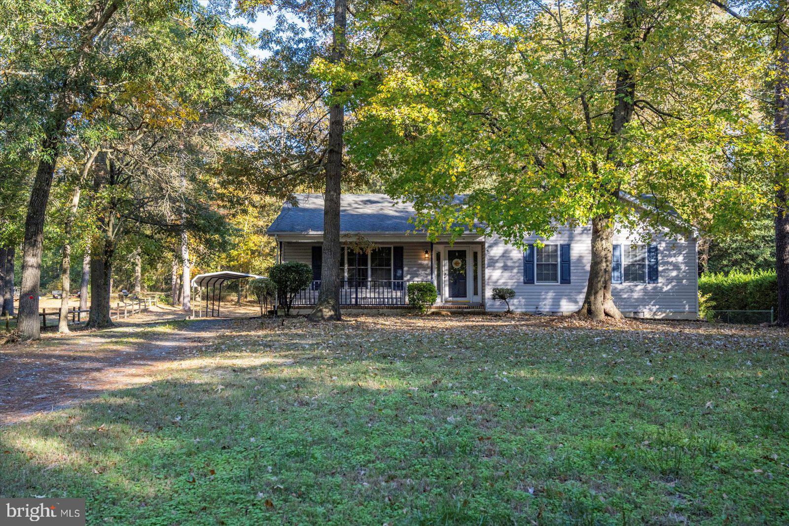 5079 Old Mill Branch Road Salisbury, MD 21801 - Photo 43 of 47 a front view of a house with a garden and trees