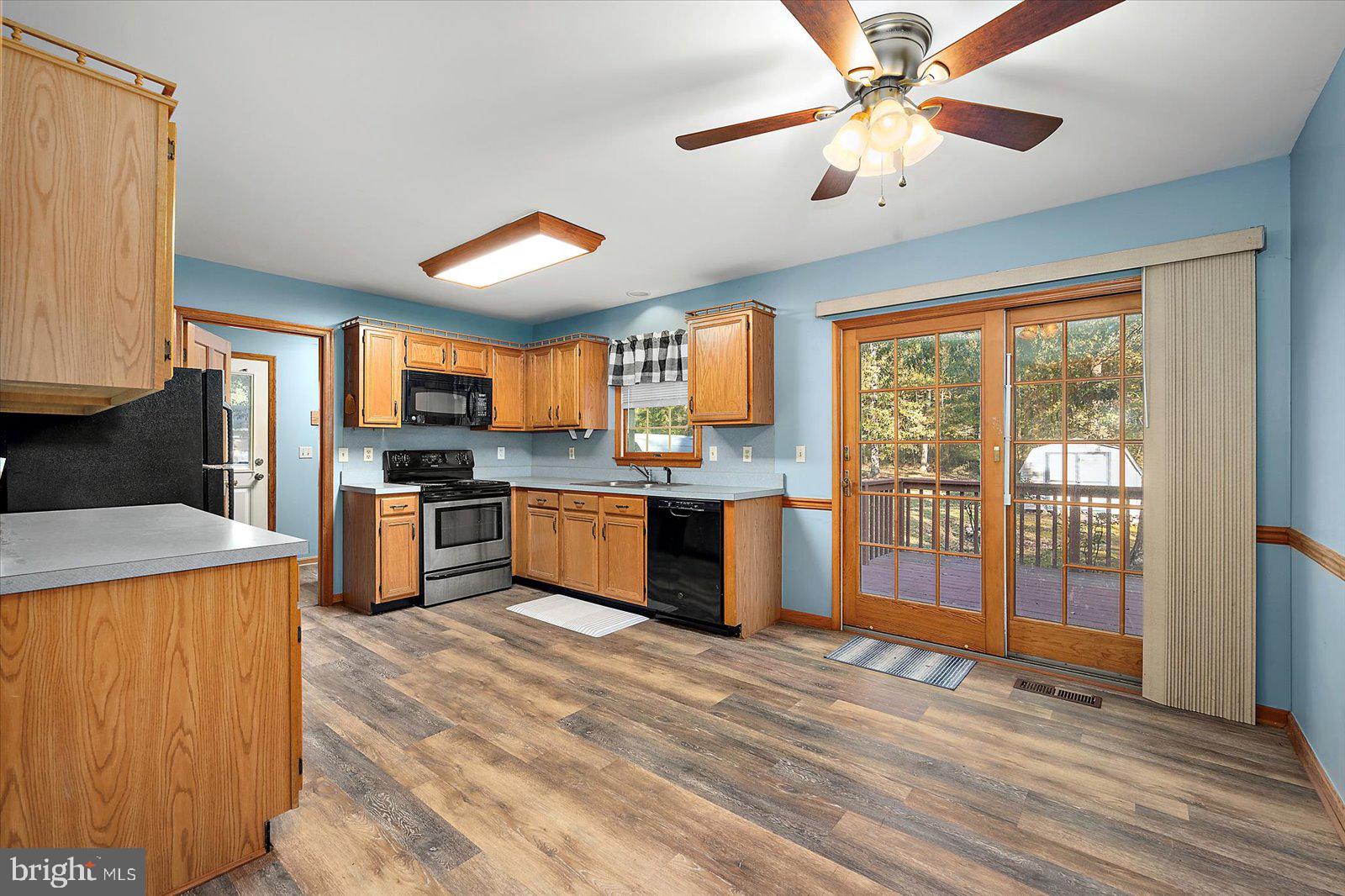 5079 Old Mill Branch Road Salisbury, MD 21801 - Photo 10 of 47 a kitchen with stainless steel appliances kitchen island granite countertop a stove top oven a sink and a granite counter top