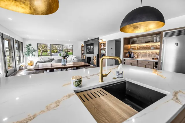 a kitchen with a sink and a stove with living room