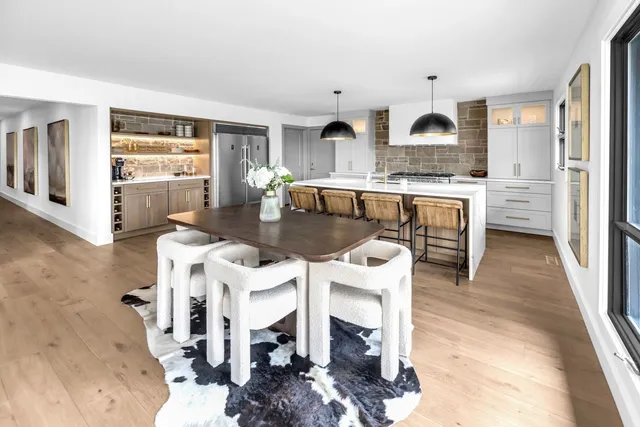 a open kitchen with stainless steel appliances kitchen island granite countertop a refrigerator and stove top oven