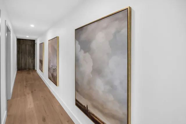 a view of hallway with wooden floor