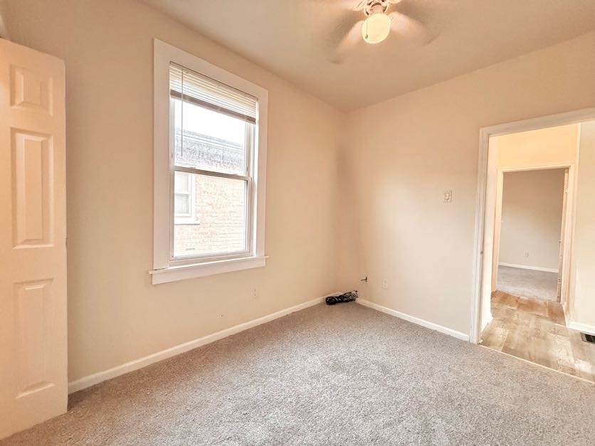 1406 West 109th Place Chicago, IL 60643 - Photo 12 of 23 an empty room with windows and fan