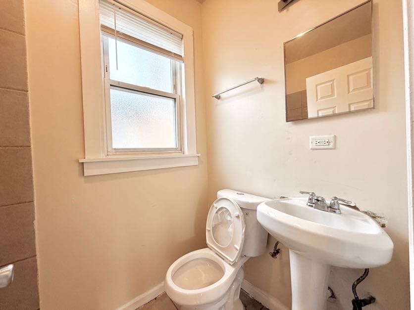 1406 West 109th Place Chicago, IL 60643 - Photo 13 of 23 a bathroom with a sink a toilet and a mirror