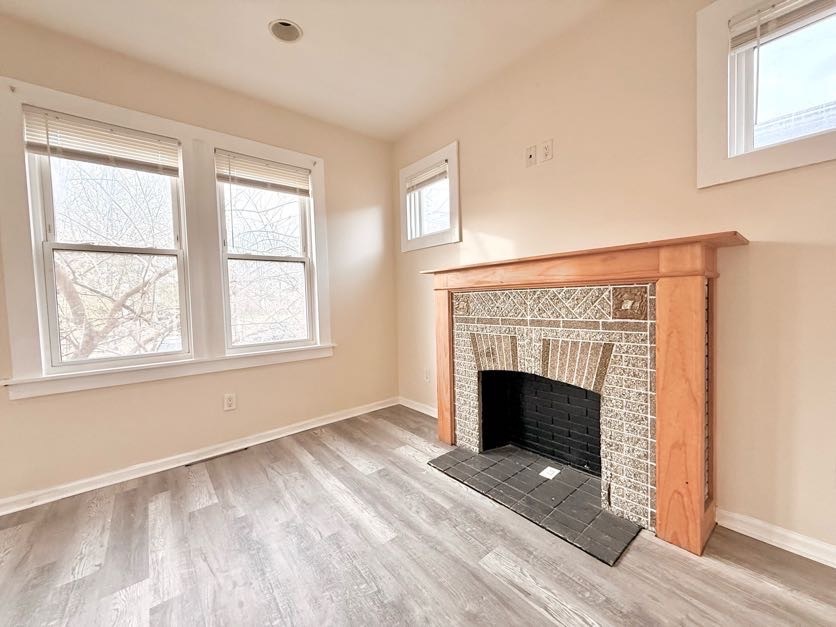 1406 West 109th Place Chicago, IL 60643 - Photo 4 of 23 an empty room with fireplace and windows