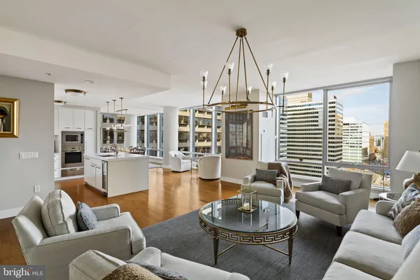 a living room with furniture a fireplace and wooden floor