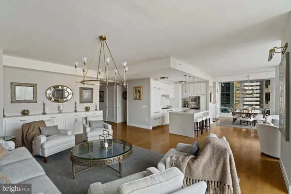 a living room with furniture and a chandelier