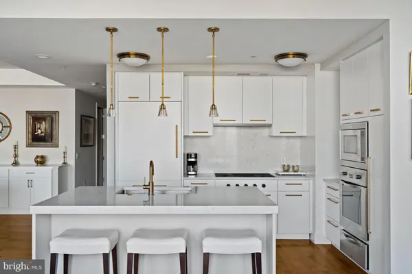 a kitchen with stainless steel appliances granite countertop a sink and cabinets