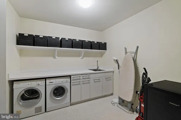 a kitchen with stainless steel appliances a sink and cabinets