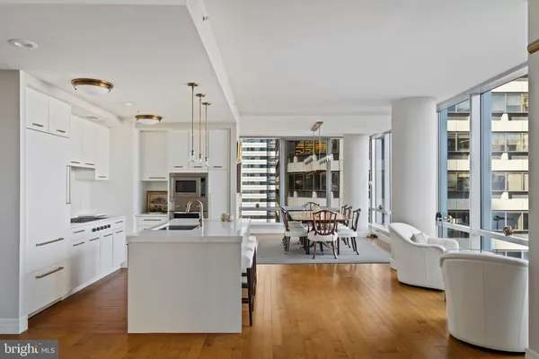 a dining room with furniture window and wooden floor