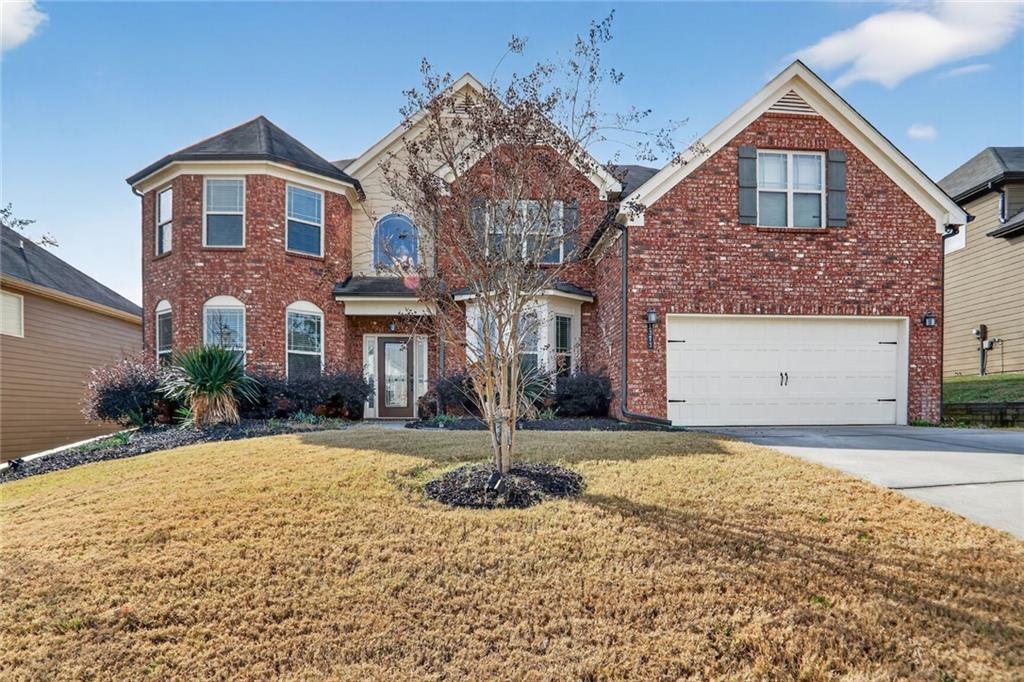 a front view of a house with a yard