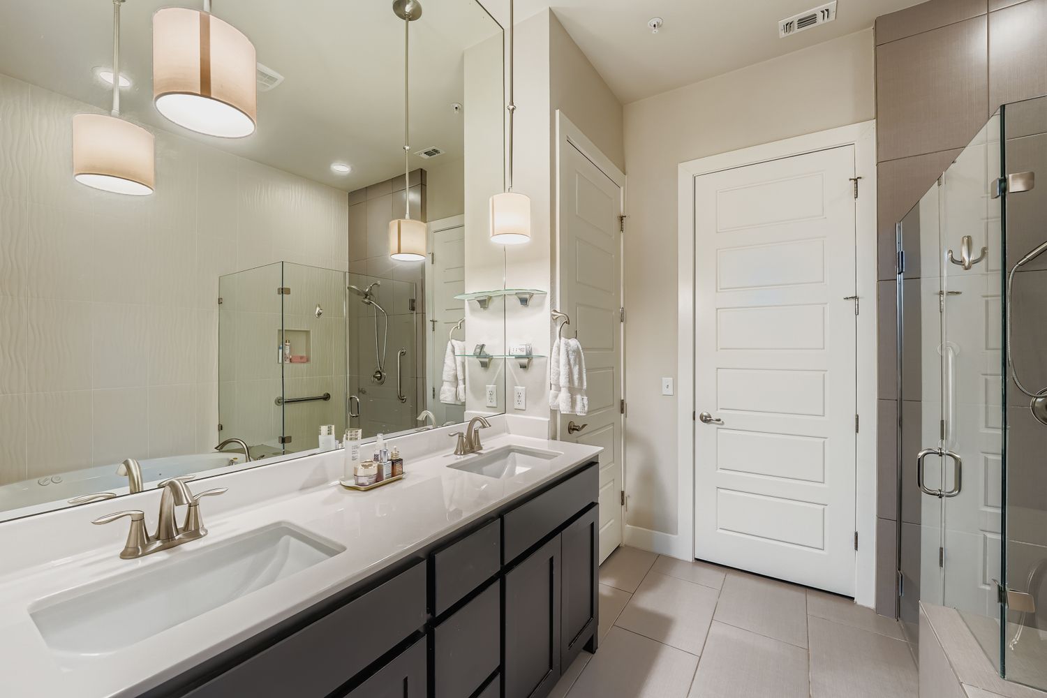 3905 Teaff Street Austin, TX 78723 - Photo 11 of 18 a bathroom with a double vanity sink a mirror and a shower