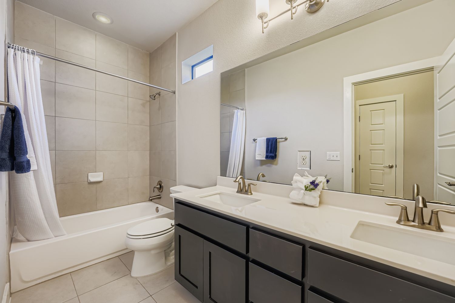 3905 Teaff Street Austin, TX 78723 - Photo 14 of 18 a bathroom with a double vanity sink toilet and shower