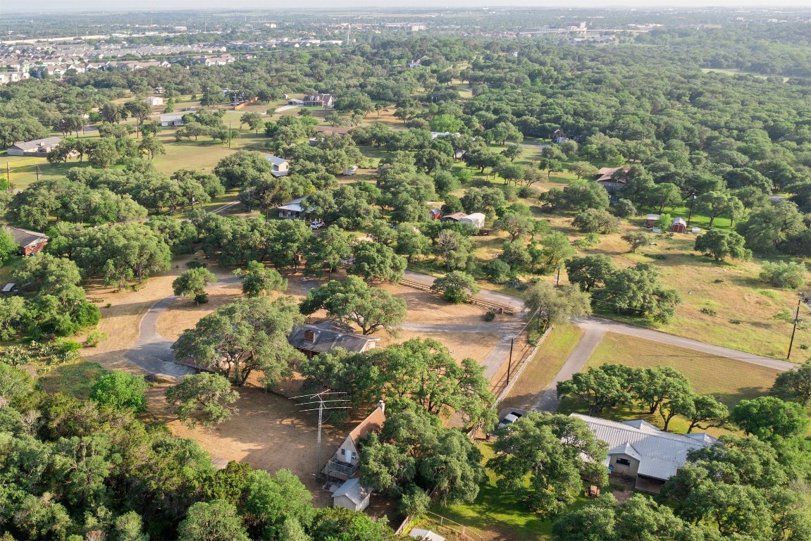 an aerial view of residential house with outdoor space and trees