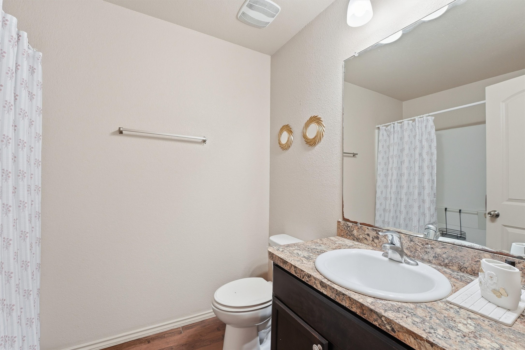 15455 Rancho Joya Way Houston, TX 77049 - Photo 12 of 20 a bathroom with a granite countertop sink a toilet and a mirror